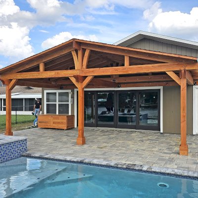 Forever Porch Pavilion (Options: 12' L x 25' W, Douglas-fir, 3-Post Anchor Kit for High-Wind, Electrical Wiring Trim for All Posts, 9 ft Posts Height, 2 Fascia Boards, No Post Decorative Trims, 2 Ceiling Fan Bases, No Curtain Rods, No Privacy Panels, Transparent Premium Sealant). Photo Courtesy of B. Carman of Ormond Beach, FL.